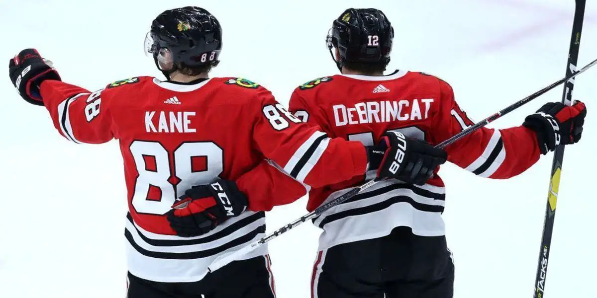 Chicago Blackhawks center Kirby Dach, right, celebrates his tying