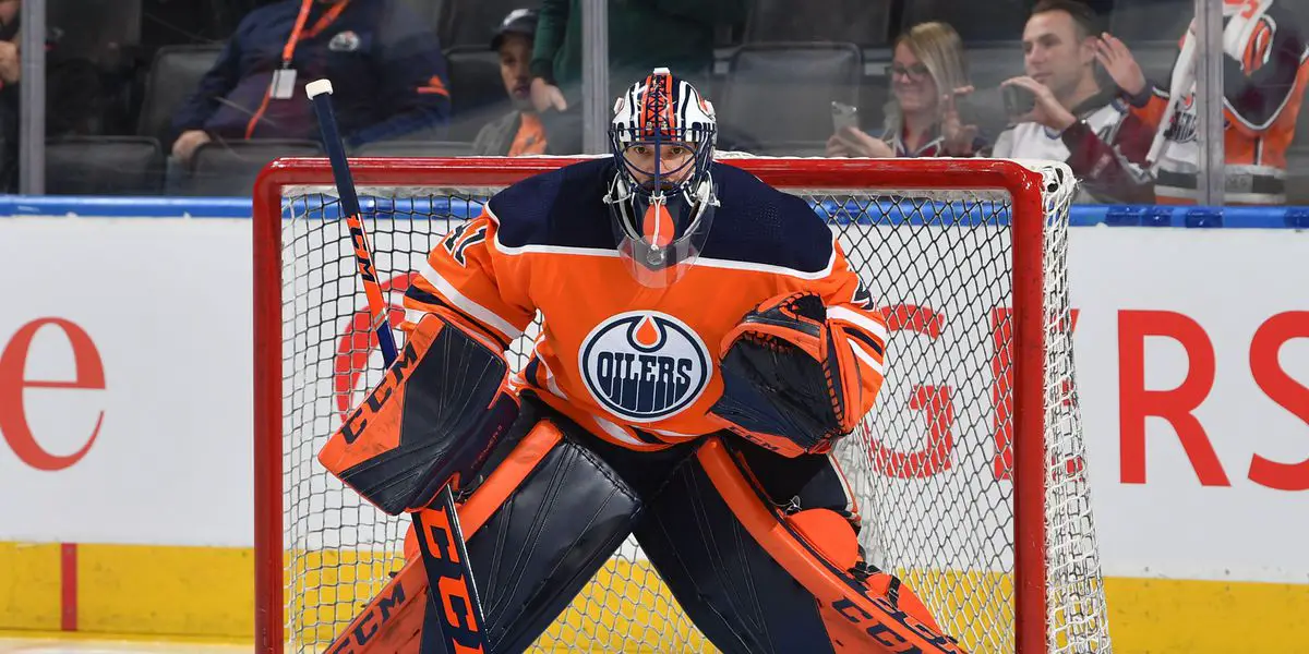 Edmonton Oilers goalie Grant Fuhr stretching before game vs