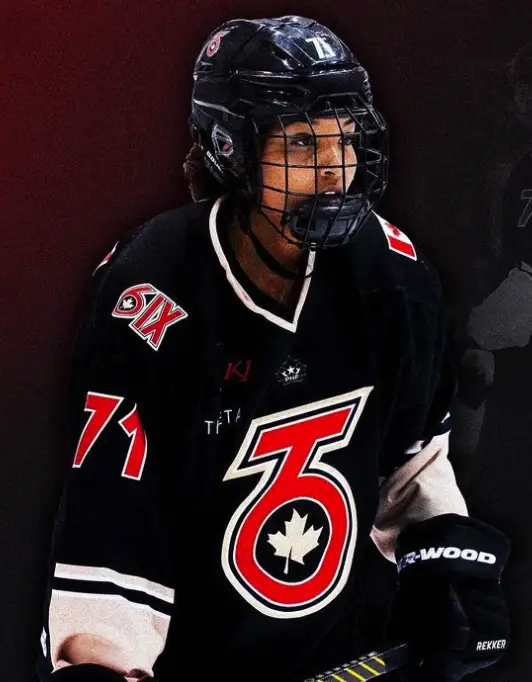 Saroya Tinker in a black Toronto Six jersey and full hockey gear.
