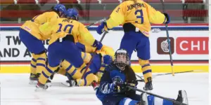 Finnish player sits on the ice after a Sweden goal