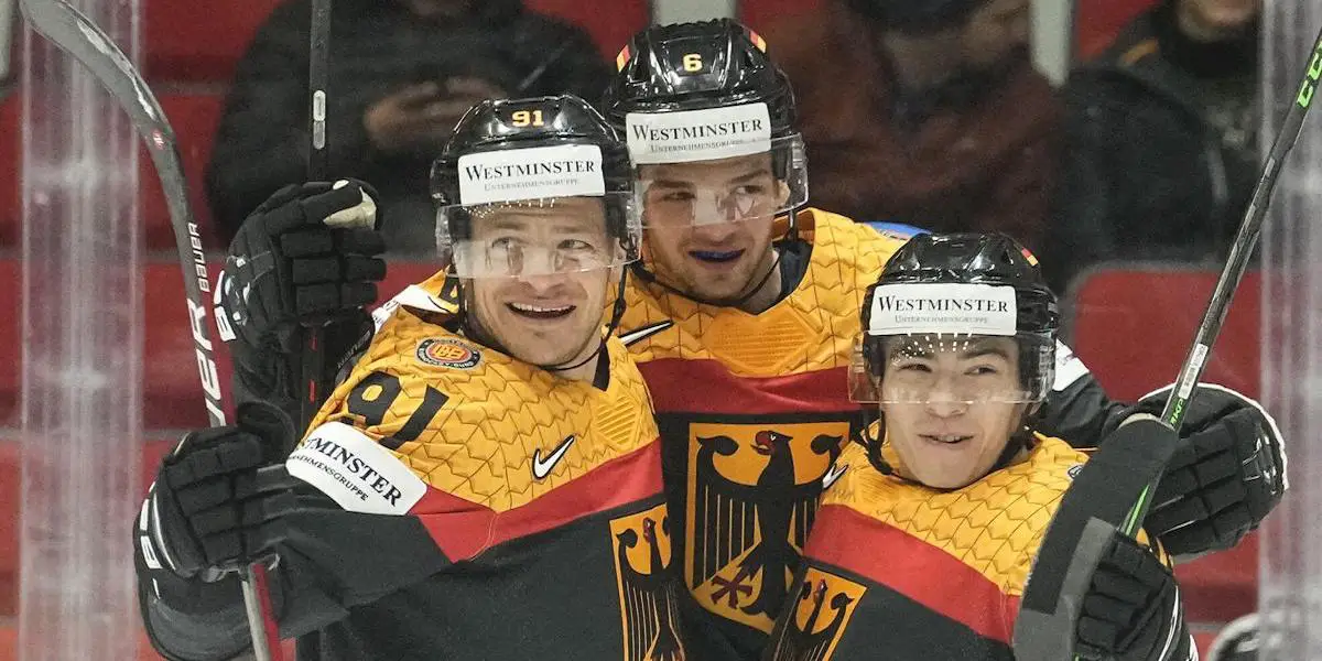 Germany's Kai Wissmann, center, celebrates with Moritz Mueller, left, and Alexander Ehl, right, after he scored the second goal during the group A Hockey World Championship match between Germany and Italy in Helsinki, Finland, Friday May 20 2022.