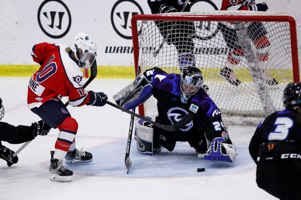 Whitecaps goalie Amanda Leveille making a save against the Riveters. 