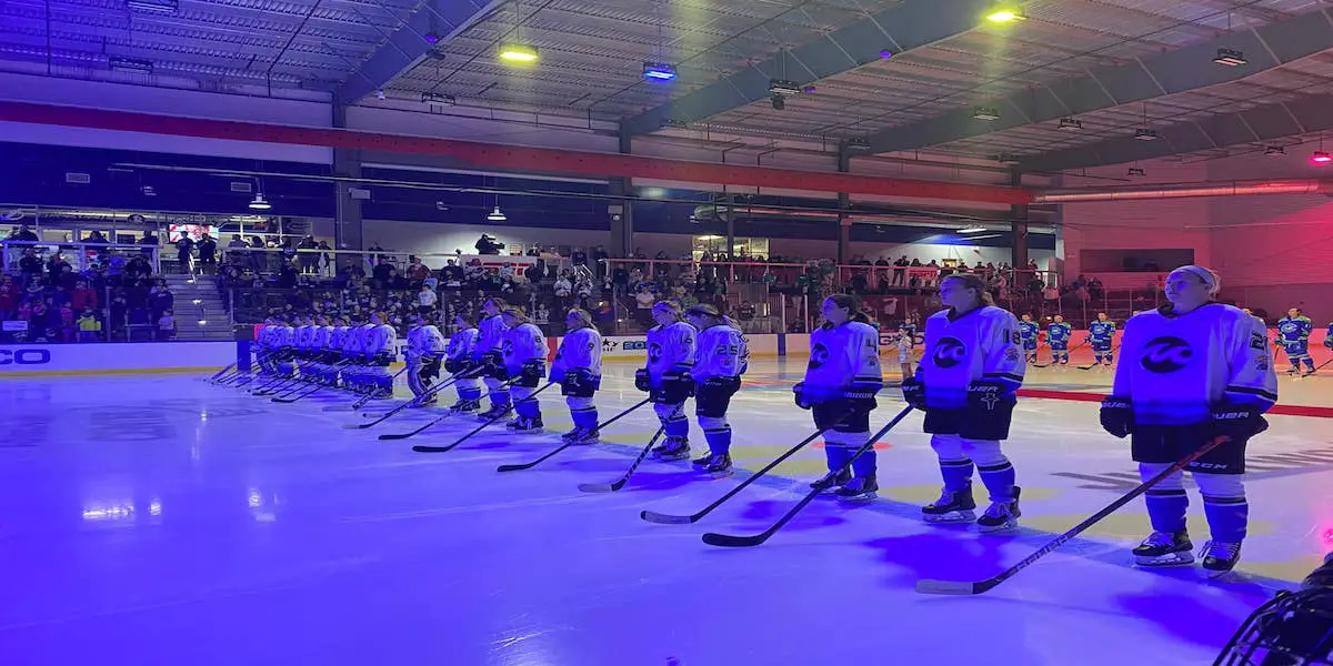 Minnesota Whitecaps players in away jerseys standing for the anthem.
