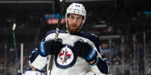 Pierre-Luc Dubois in a Winnipeg Jets uniform doing the Superman Celly after a goal.