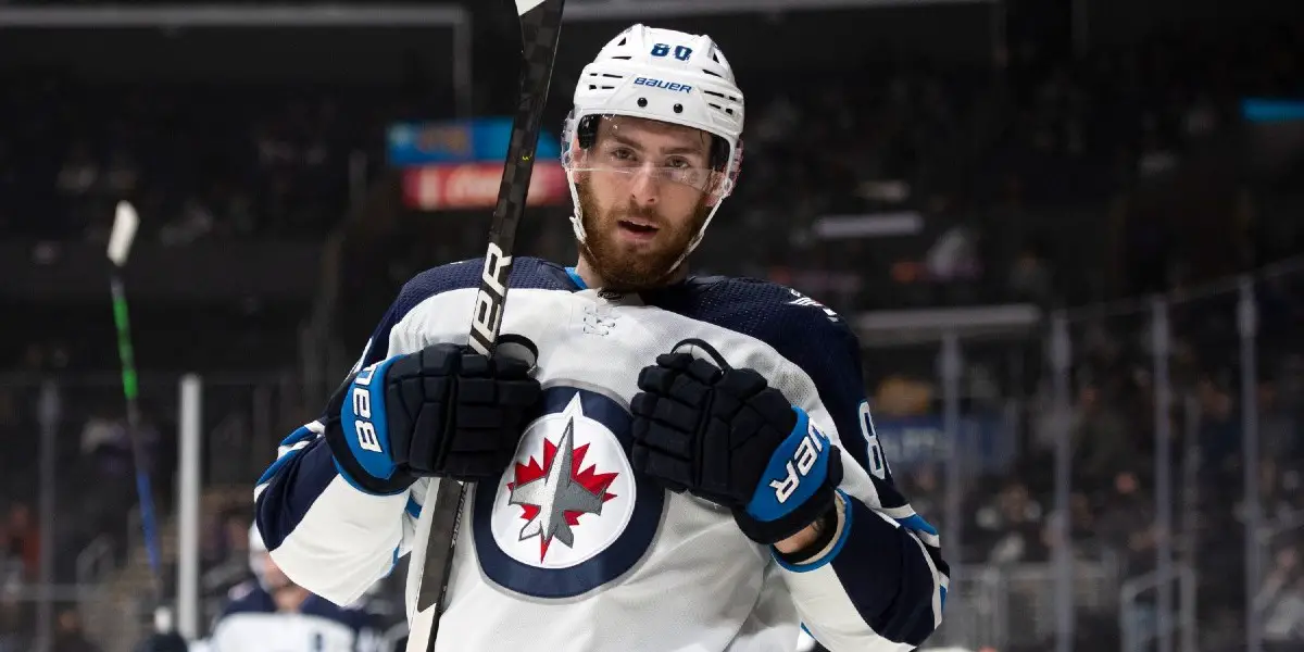 Pierre-Luc Dubois in a Winnipeg Jets uniform doing the Superman Celly after a goal.