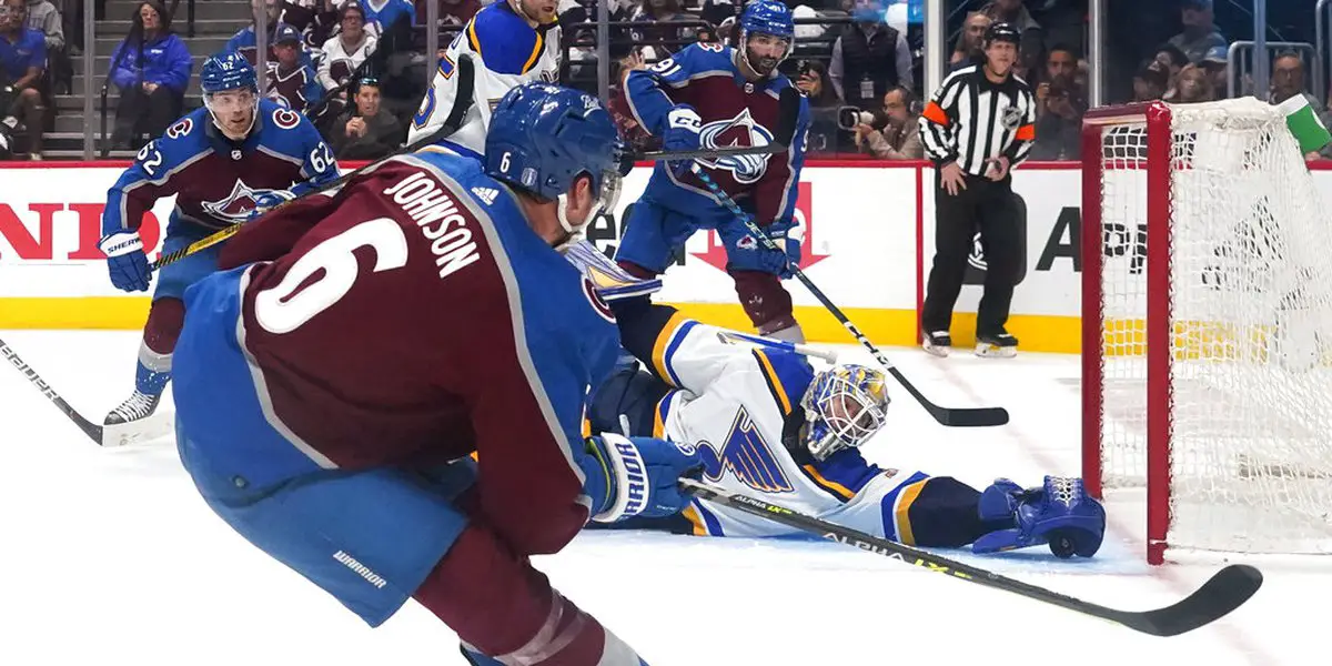 Erik Johnson and Gabriel Landeskog of the Colorado Avalanche hoist