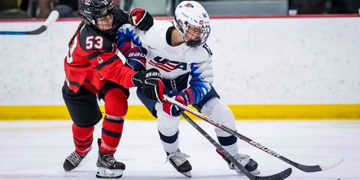 Canadian Eloïse Caron battles American Rose Dywer for the puck