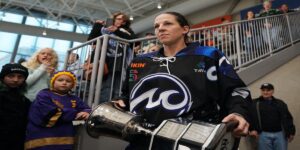 Brodt-Brown with the Isobel Cup in a black Whitecaps jersey