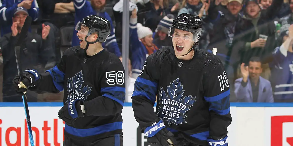 Mitch Marner and Michael Bunting celebrating in Leafs alternate jerseys