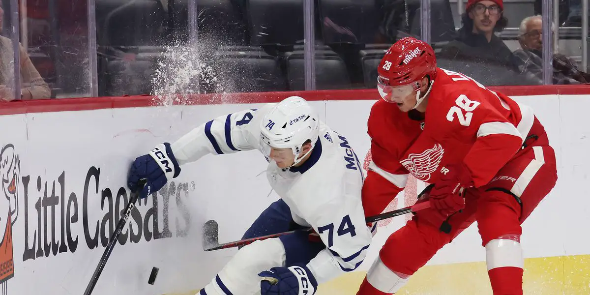 Leafs Forward Bobby McMann Taken Down by Detroit Red Wings Defenseman in Corner