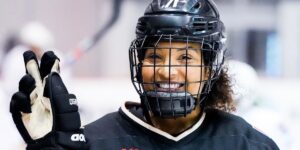 Toronto Six defender Saroya Tinker smiling for the camera, holding 2 fingers up