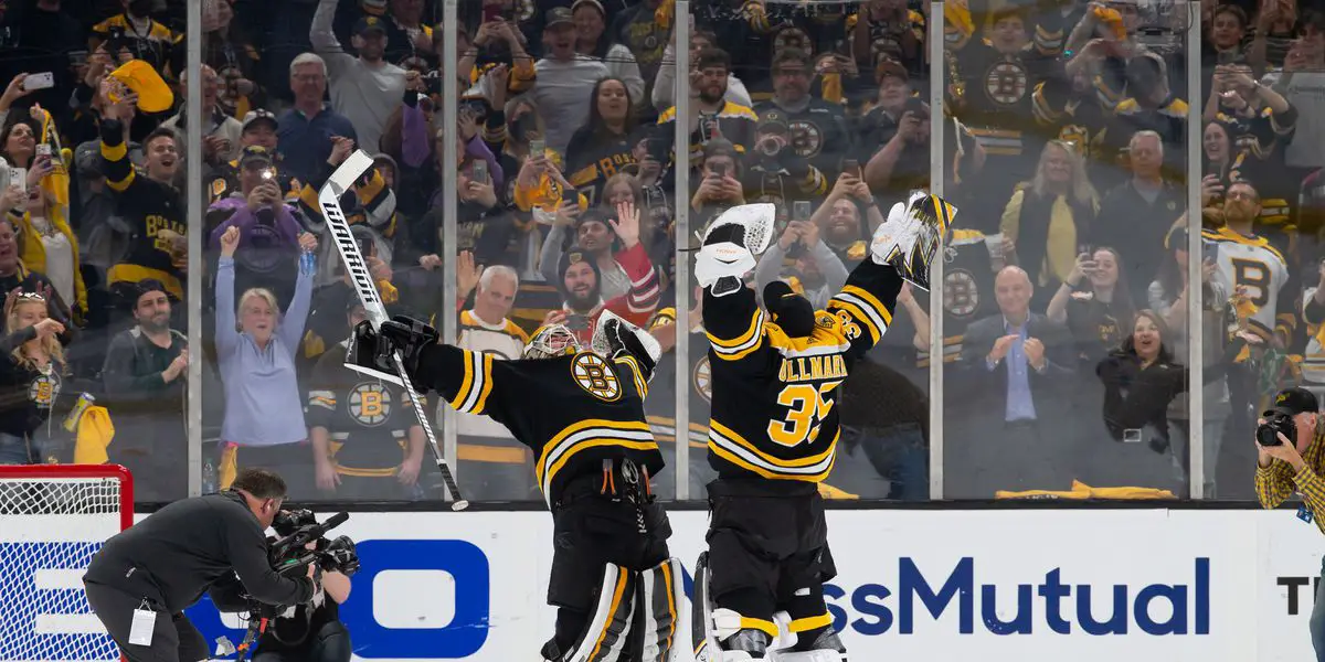 Linus Ullmark and Jeremy Swayman hugging after a Bruins win.