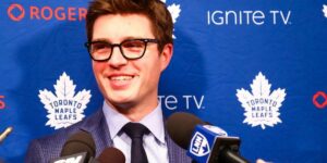 Toronto Maple Leafs General Manager Kyle Dubas Smiling While Talking to the Media