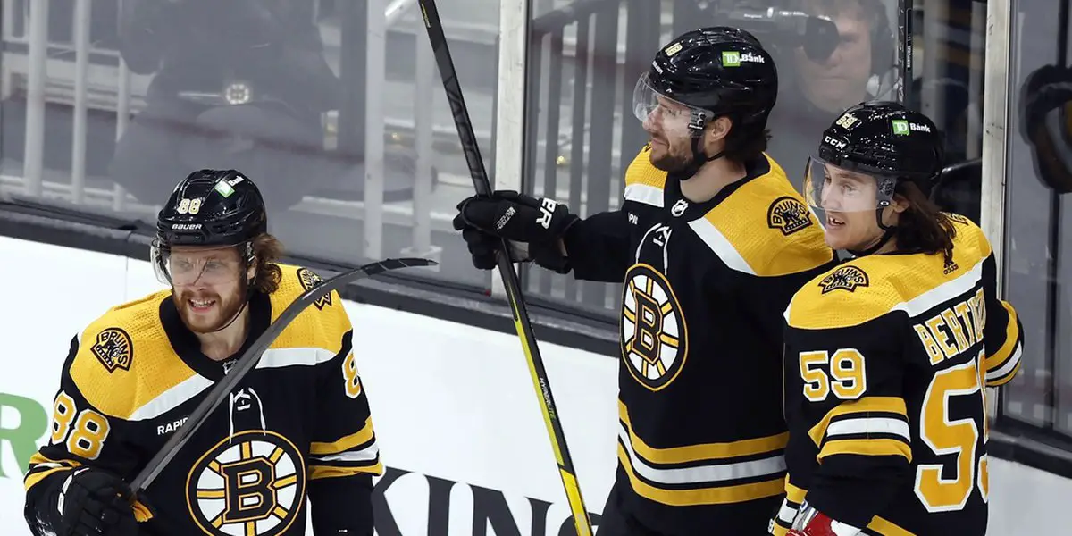 Boston Bruins' Pavel Zacha (18) celebrates with David Pastrnak (88) and Tyler Bertuzzi (59) after making his second goal during the first period of an NHL hockey game against the New Jersey Devils, Saturday, April 8, 2023, in Boston. (AP Photo/Michael Dwyer)(APMedia)