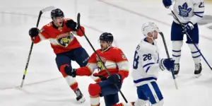 Florida Panthers center Sam Reinhart, center, celebrates scoring the game-winning goal against the Toronto Maple Leafs during overtime of Game 3 of an NHL hockey Stanley Cup second-round playoff series, Sunday, May 7, 2023, in Sunrise, Fla. (AP Photo/Michael Laughlin)