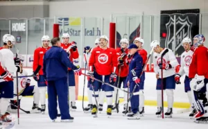 Members of the Washington Capitals are coached by Peter Laviolette during a practice during the 2022-23 season.