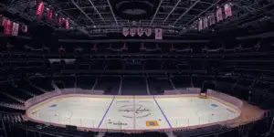 A wide-angle photo of an empty Capital One Arena with freshly-laid ice for the upcoming hockey season.