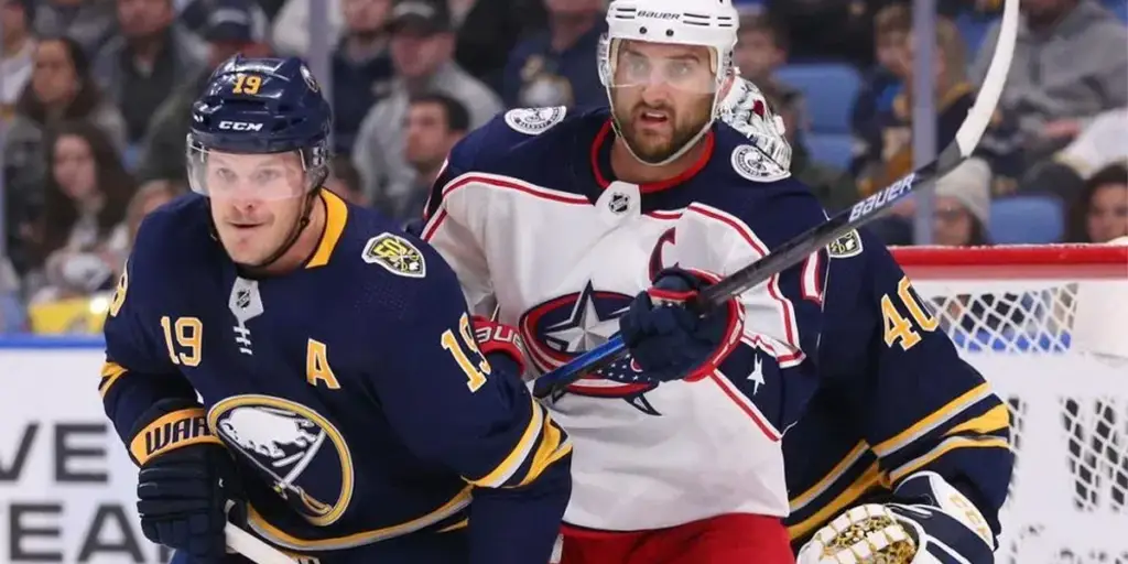 Jake McCabe and Nick Foligno in front of the net (AP Photo/Jeffrey T. Barnes)