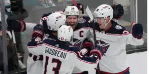 Veterans Boone Jenner and Johnny Gaudreau and team celebrate goal