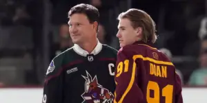 Josh Doan and his father Shane drop the ceremonial puck during the first ever Arizona Coyotes game at Mullett Arena
