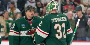 Filip Gustavsson and Marc-Andre Fleury discuss on the ice while in Minnesota Wild uniforms