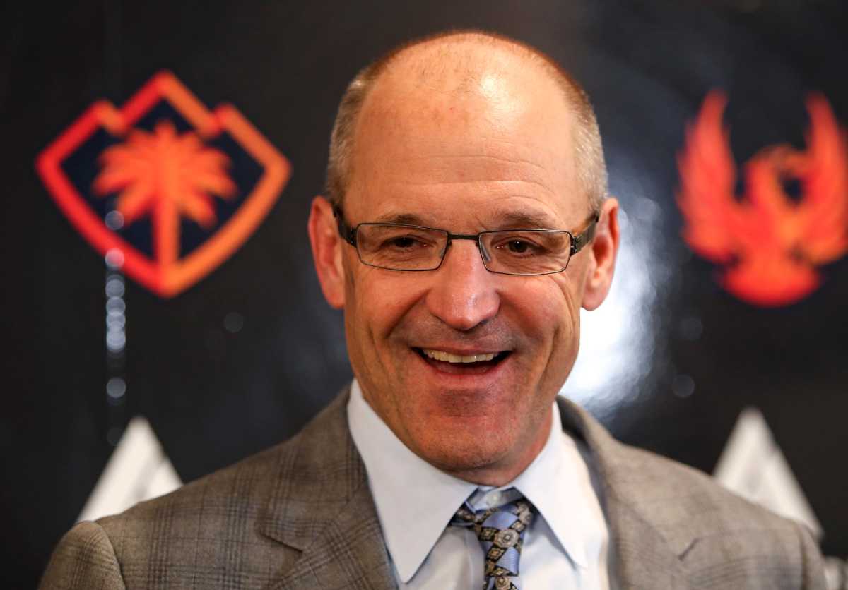 Dan Bylsma smiling in front of Coachella Valley Firebirds background
