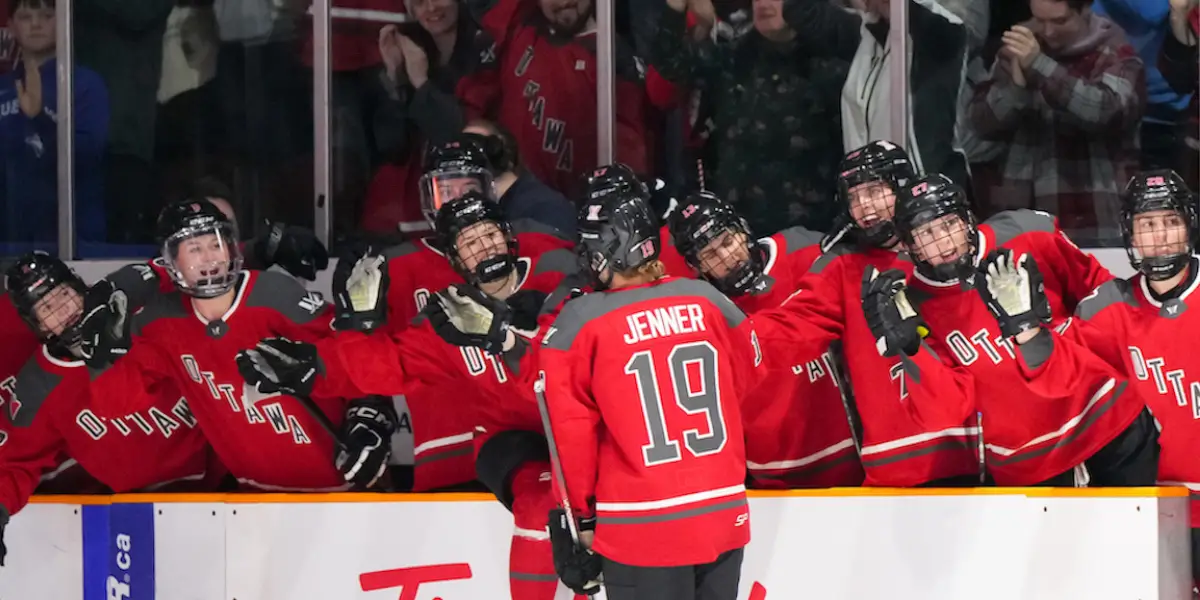 PWHL Ottawa captain Brianne Jenner celebrating a goal with her teams bench