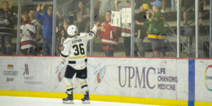 Koopman tosses a young fan a puck after eliminating the Indy Fuel in the Kelly Cup Playoffs.