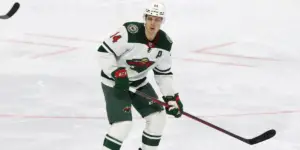 Joel Eriksson Ek on the ice in a white Minnesota Wild jersey