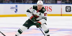 Kirill Kaprizov skating on the ice wearing a white Minnesota Wild jersey with an A for alternate captain