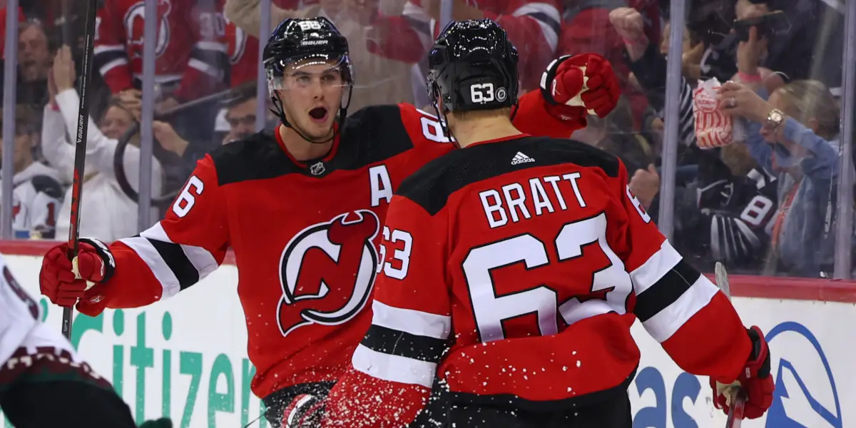 Jack Hughes and Jesper Bratt celebrate a goal.