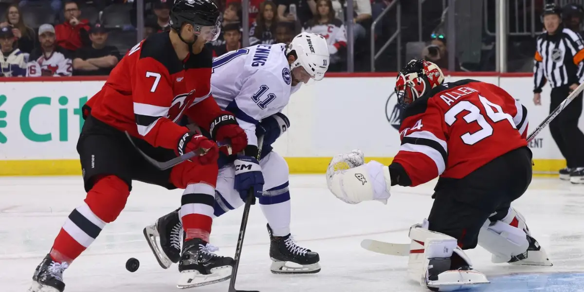 Dougie Hamilton and Luke Glendening battle for the puck in front of Jake Allen.