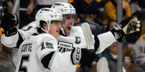 Anze Kopitar #11 and Alex Turcotte #15 of the Los Angeles Kings