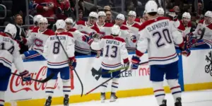 Cole Caufield #13 & Montreal Canadiens bench celebrating a goal