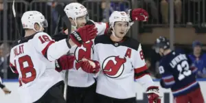 Ondrej Palat, Brett Pesce and Jack Hughes celebrate a goal against the Rangers.