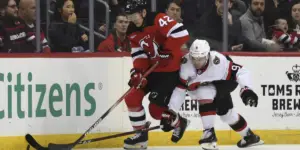 Curtis Lazar and Josh Norris battle for the puck.