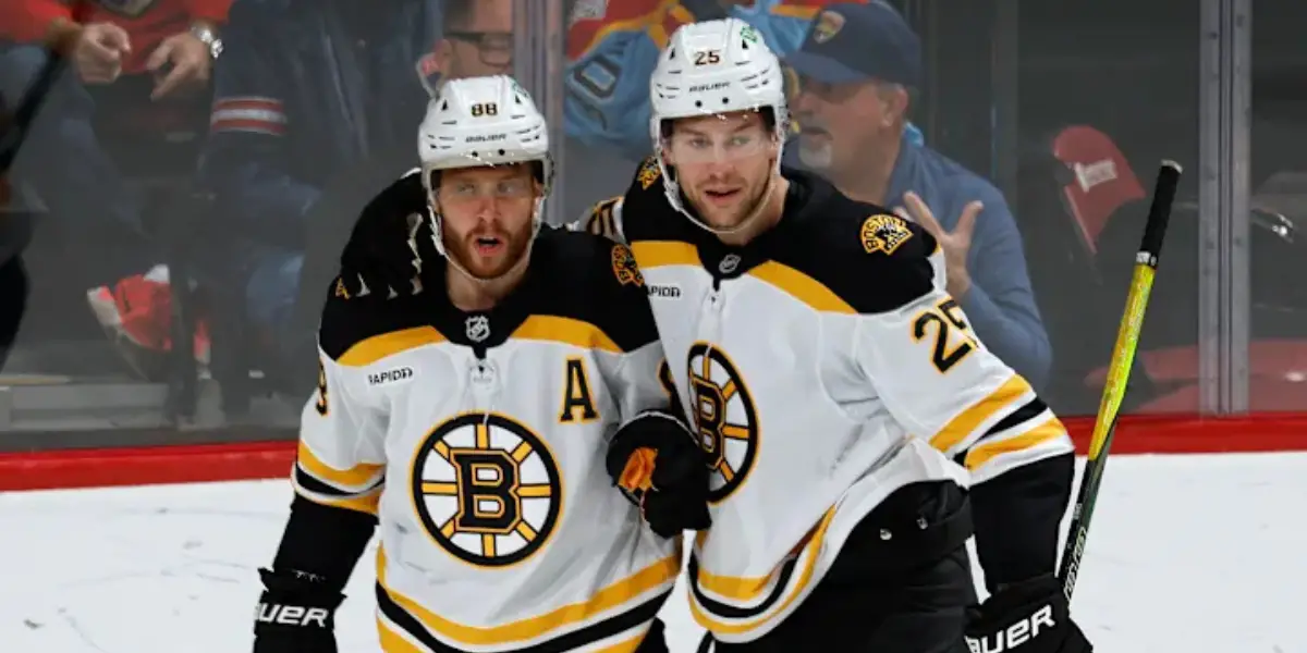 David Pastrnak and Brandon Carlo skating for the Boston Bruins