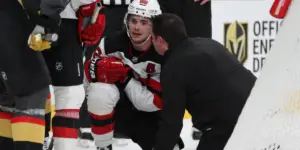 Jack Hughes speaks with the medical staff after suffering a scary injury late in the third period against the Vegas Golden Knights.