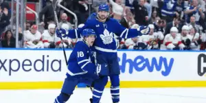 Mitch Marner and Chris Tanev celebrating a goal