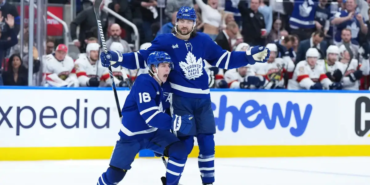 Mitch Marner and Chris Tanev celebrating a goal